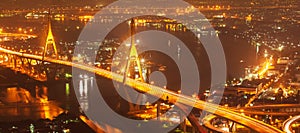 Aerial view of Bhumibol Suspension Bridges and highways interchange over the Chao Phraya River at dusk. Samut Prakan, Thailand