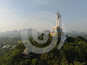 An aerial view of Big Buddha on the mountain stands prominently at Nong Hoi Temple in Ratchaburi near the Bangkok, Thailand.