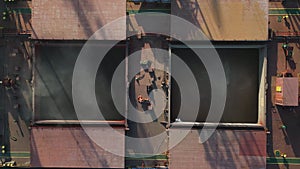 Aerial view of big cargo ship bulk carrier is loaded with grain of wheat in port at sunset