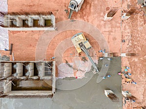 Aerial view of big excavator with concrete truck on construction and worker pouring a wet concret at construction site, Concrete