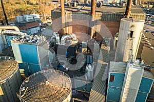 Aerial view of big fuel reservoirs in petroleum industrial zone and metal exhaust pipes of oil refinery factory