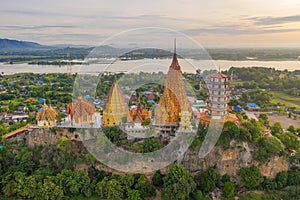 Aerial view of Big Golden Buddha Statue and pagoda in Tiger Cave Temple or Wat Tham Suea in Kanchanaburi province, Thailand.