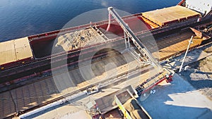 Aerial view of big grain elevators on the sea. Loading of grain on ship. Port Ukraine. Cargo ship