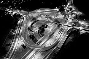 Aerial view of big highway interchange with traffic  at night. Scenic cityscape. transportation, communications and driving