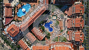 aerial view of big modern hotel or condominium with swimming pool and palms