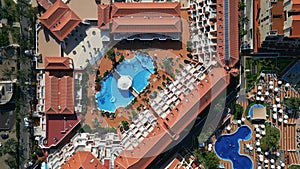 aerial view of big modern hotel or condominium with swimming pool and palms