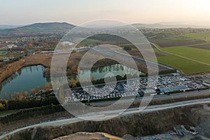 Aerial view of big parking lot of junkyard with rows of discarded broken cars. Recycling of old vehicles