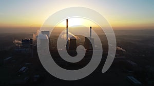 Aerial view of big powerhouse during sunrise. Big industry chimneys in power plant.