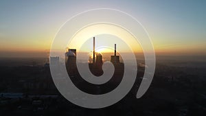 Aerial view of big powerhouse during sunrise. Big industry chimneys in power plant.