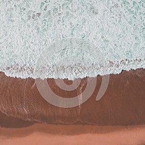 Aerial view of a big sandy beach with waves . Portuguese coastline