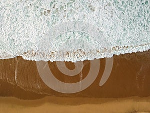 Aerial view of a big sandy beach with waves . Portuguese coastline