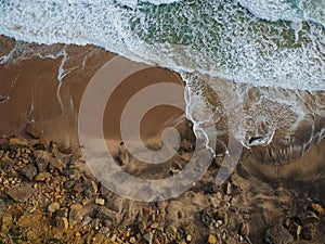 Aerial view of a big sandy beach with waves . Portuguese coastline