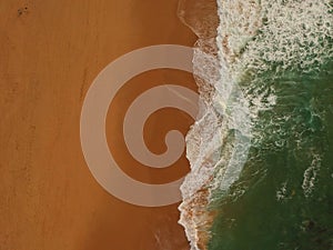 Aerial view of a big sandy beach with waves . Portuguese coastline