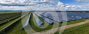 Aerial view of big sustainable electric power plant with many rows of solar photovoltaic panels for producing clean