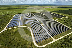 Aerial view of big sustainable electric power plant with many rows of solar photovoltaic panels for producing clean