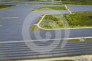 Aerial view of big sustainable electric power plant with many rows of solar photovoltaic panels for producing clean