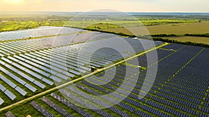 Aerial view of big sustainable electric power plant with rows of solar photovoltaic panels for producing clean