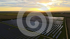 Aerial view of big sustainable electric power plant with rows of solar photovoltaic panels for producing clean