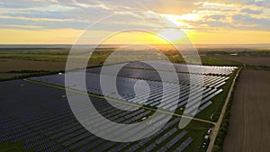 Aerial view of big sustainable electric power plant with rows of solar photovoltaic panels for producing clean