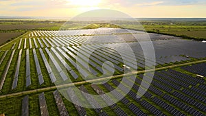 Aerial view of big sustainable electric power plant with rows of solar photovoltaic panels for producing clean