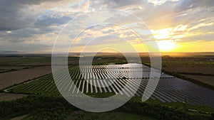 Aerial view of big sustainable electric power plant with rows of solar photovoltaic panels for producing clean