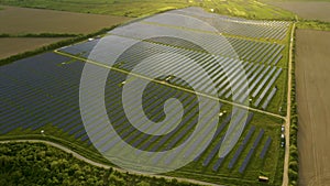 Aerial view of big sustainable electric power plant with rows of solar photovoltaic panels for producing clean