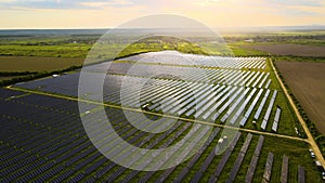 Aerial view of big sustainable electric power plant with rows of solar photovoltaic panels for producing clean