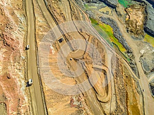 Aerial view of big trucks in huge, open pit mine