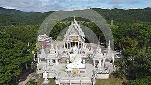 Aerial view of big white Buddha statue in temple. Sumnuk Song Numpu Ron Monastery in Ban Kha, Ratchaburi, Thailand.