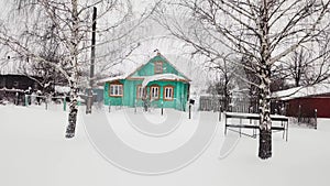 Aerial view between birch tree authentic wooden rustic green house facade winter