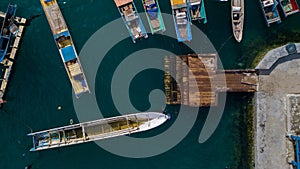 Aerial view or bird view of jetty with many wooden boats are docking