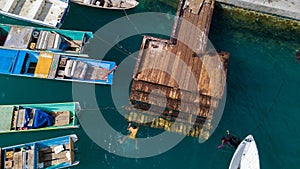 Aerial view or bird view of jetty with many wooden boats are docking