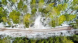 Aerial View Of Black Car On Snow Covered forest road