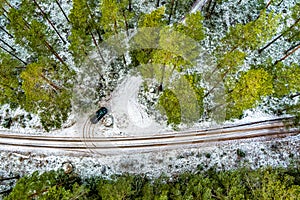 Aerial View Of Black Car On Snow Covered forest road