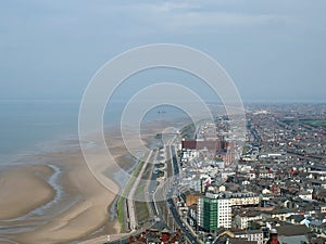 Aerial view of blackpool looking south showing the beach at low tide with the roads and buildings of the town and coast