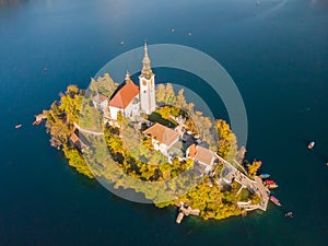 Aerial view of Bled island on lake Bled, and Bled castle and mountains in background, Slovenia. photo