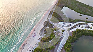 Aerial view of Blind Pass beach on Manasota Key, USA. Many people enjoying vacation time swimming in gulf water and