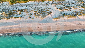 Aerial view of Blind Pass beach on Manasota Key, USA. Many people enjoying vacation time swimming in gulf water and