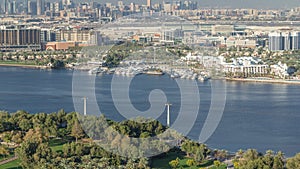 Aerial view of blue canal near green park Dubai city, United Arab Emirates Timelapse