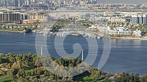 Aerial view of blue canal near green park Dubai city, United Arab Emirates Timelapse