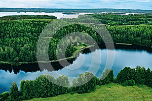 Aerial view of blue lakes and green woods sunny summer day in Finland from above