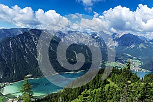 Aerial view of blue mountain lake between forested rocky mountains. Achensee, Austria, Tyrol photo