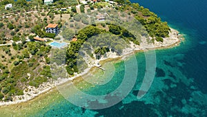 Aerial view of a blue ocean near a cliffy shore at daytime