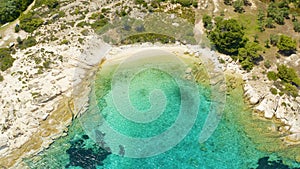 Aerial view of a blue ocean near a cliffy shore at daytime