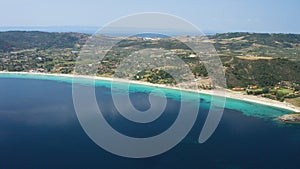 Aerial view of a blue ocean near a cliffy shore at daytime