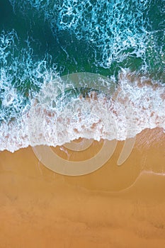 Aerial view of Blue ocean wave on sand beach.