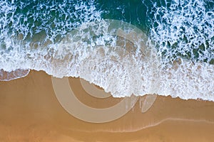 Aerial view of Blue ocean wave on sand beach.