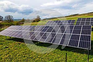 Aerial view of blue photovoltaic solar panels mounted on backyard ground for producing clean ecological electricity. Production of