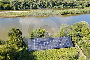 Aerial view of blue photovoltaic solar panels mounted on backyard ground for producing clean ecological electricity. Production of