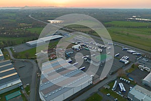 Aerial view of blue photovoltaic solar panels mounted on industrial building roof for producing green ecological